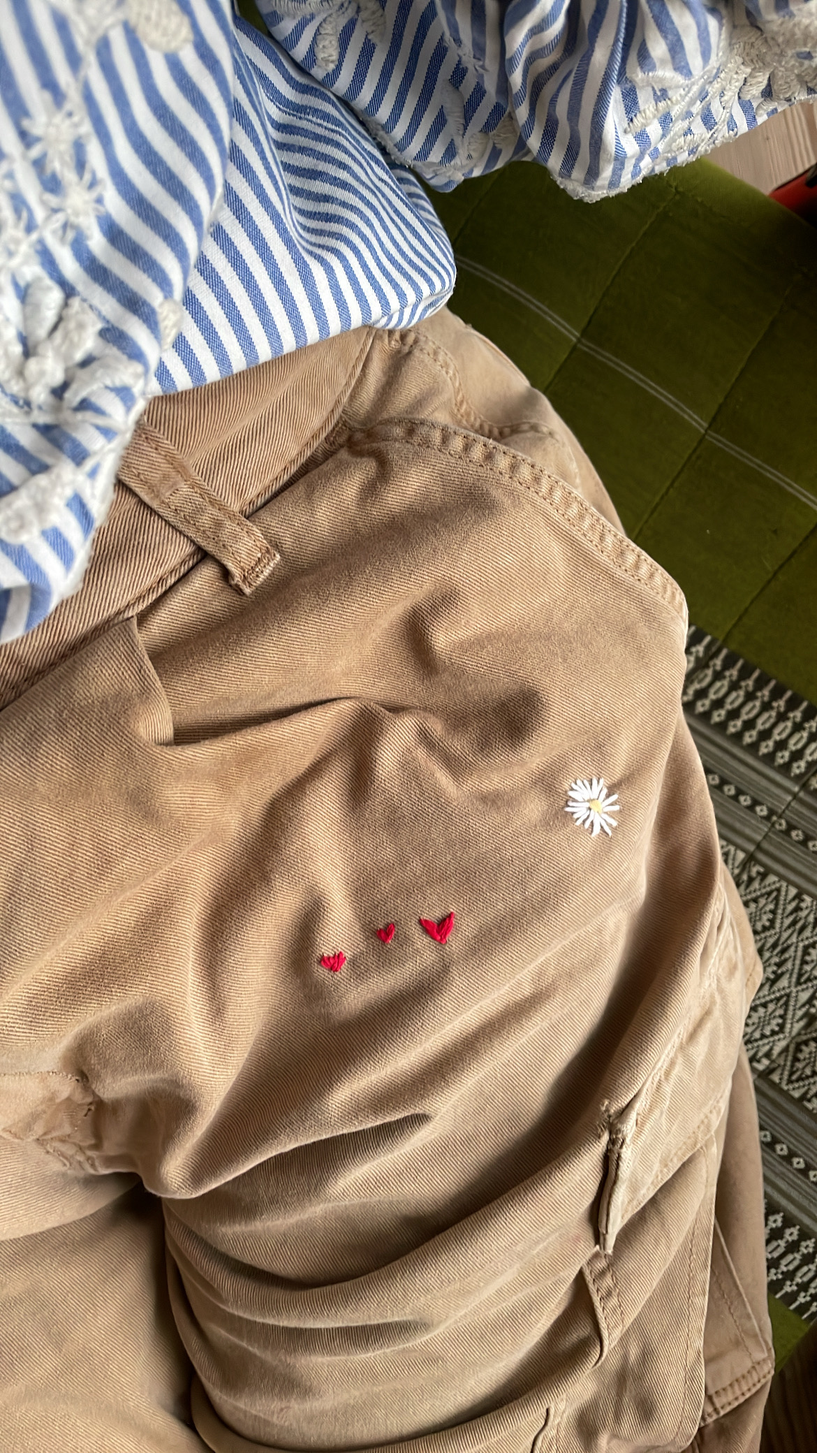 Upcycled trousers with embroidered heart and daisy accen